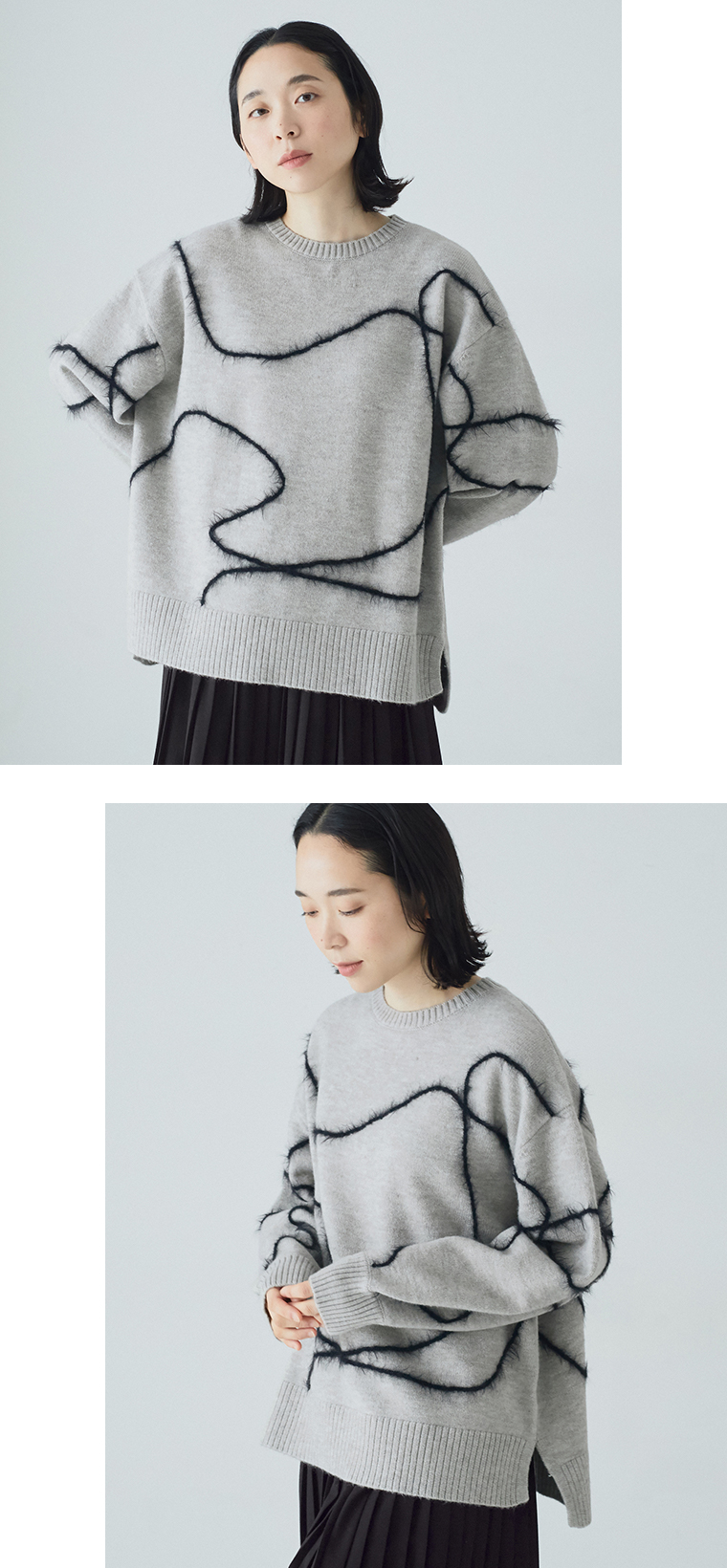 抽象ライン入りグレーニットを黒のプリーツパンツに合わせた正面コーディネート