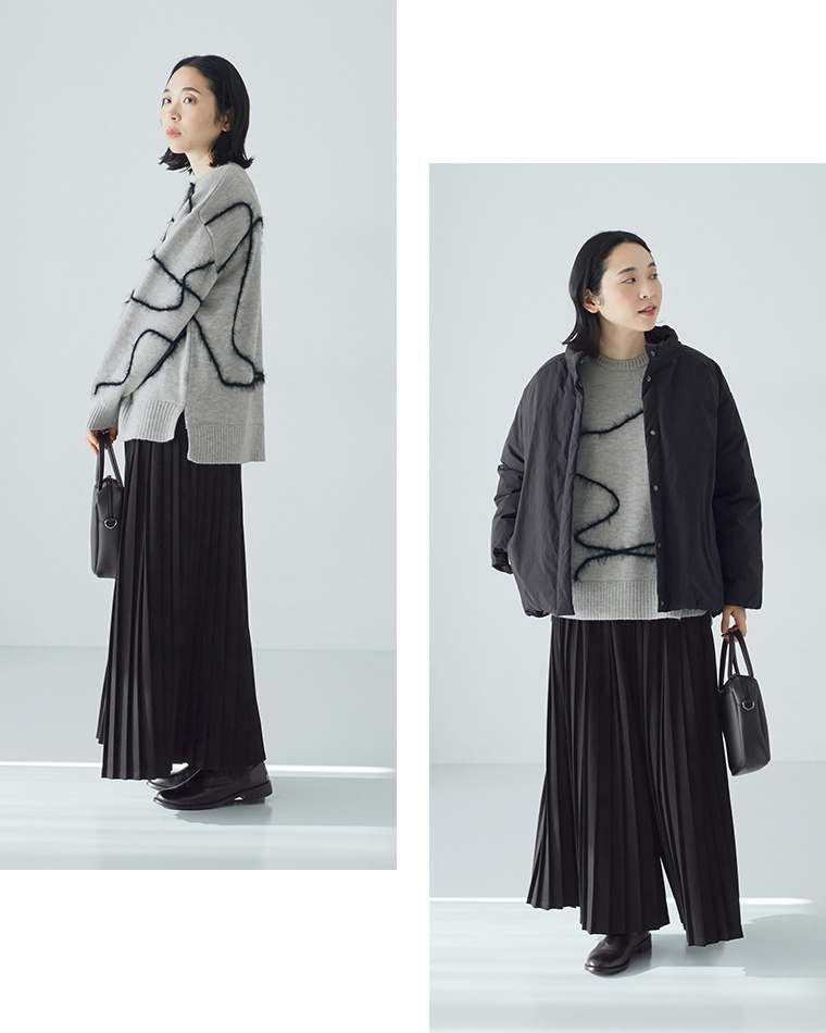 抽象ライン入りグレーニットに黒のダウンジャケットを重ねた冬のレイヤードコーディネート